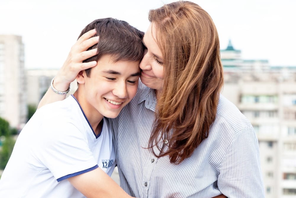 Mum and teenager with eating disorder hug during recovery