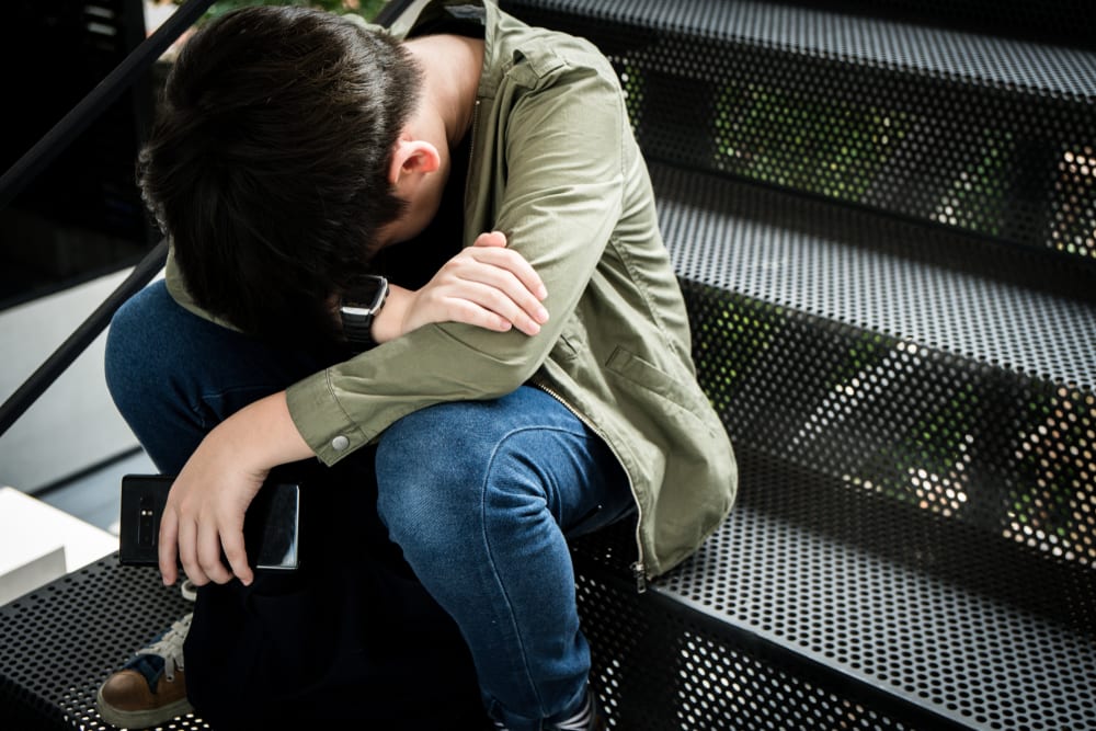 Young boy with an eating disorder is sad and along and needs mental health and family support